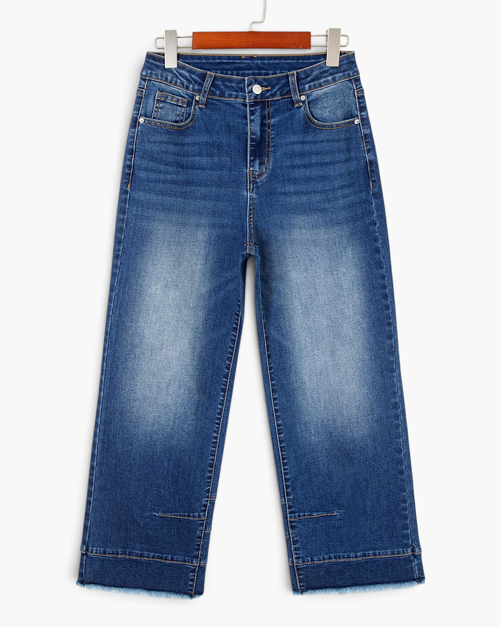 Beach Rose Co. medium wash high-rise wide-leg jeans with seamed cuffs and raw hems on a wooden hanger.