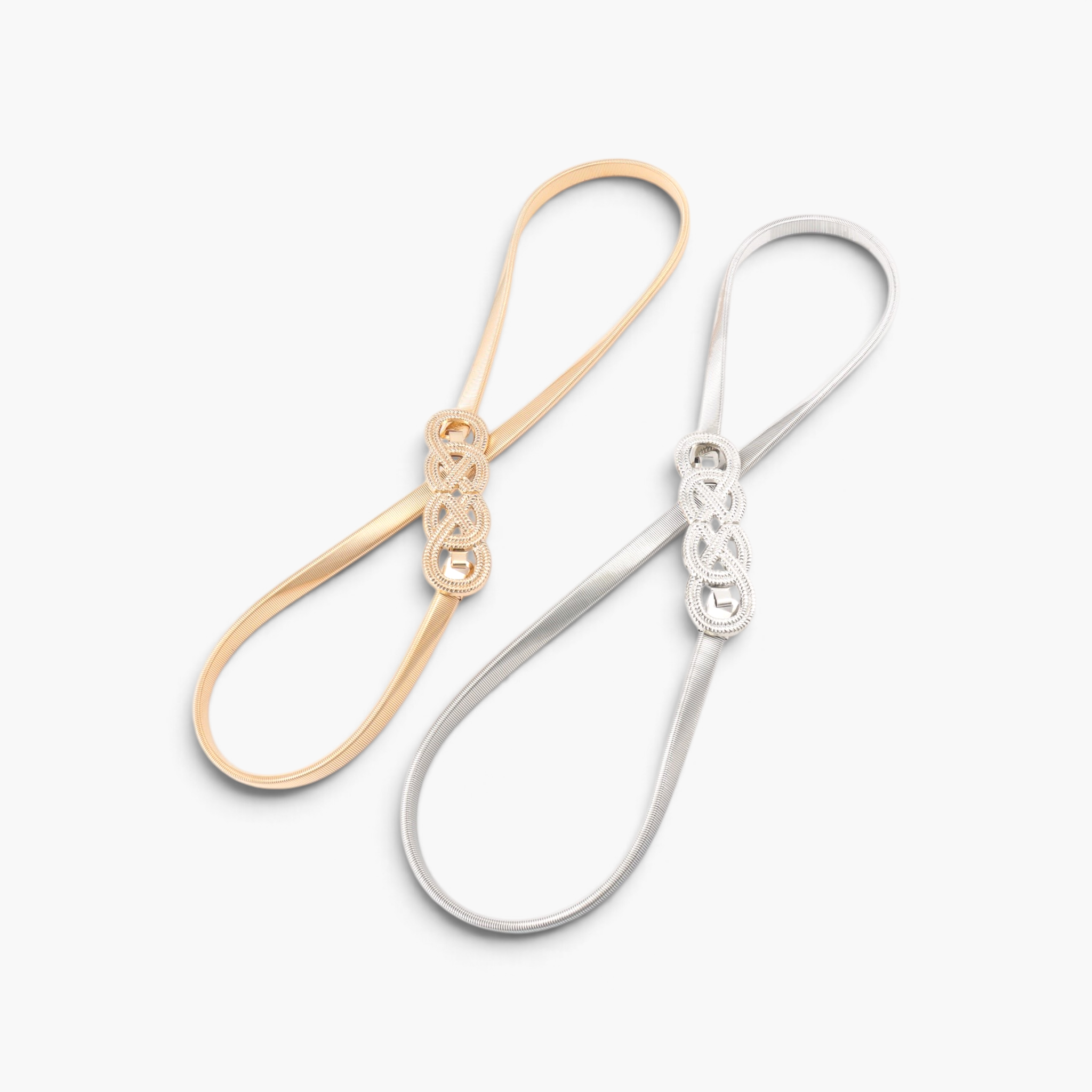 Beach Rose Co. slim metal waist belts in gold and silver with intricate interwoven knot buckles and ridged bands.