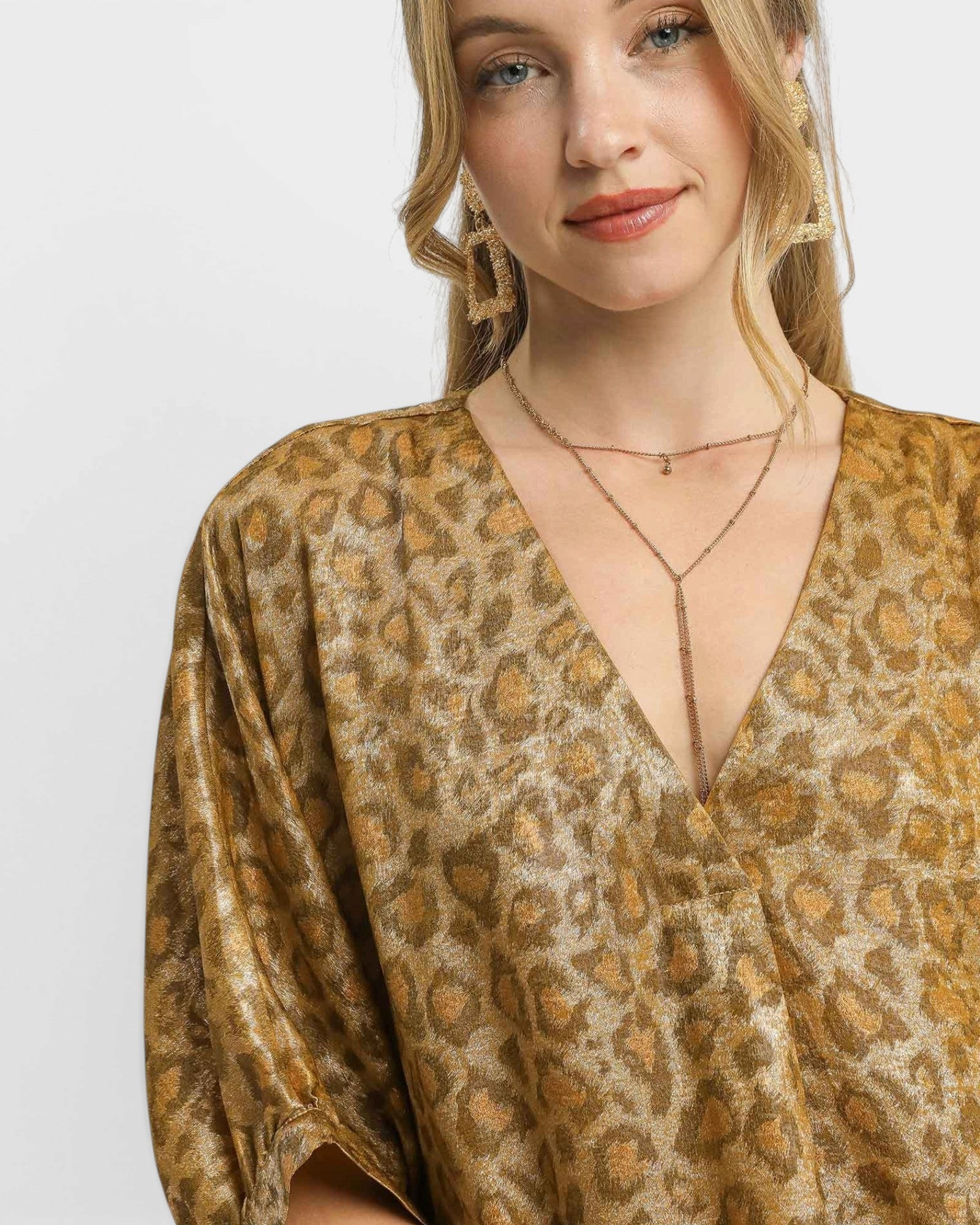 Beach Rose Co. brown leopard print shift dress with a metallic finish, V-neckline, and elbow-length sleeves.