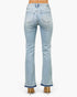 Beach Rose Co. light wash mid-rise flare jeans with a raw released hem, viewed from the back on a model in heels.
