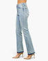 Beach Rose Co. mid-rise flare jeans in light wash denim with a raw released hem, worn with beige stiletto heels.