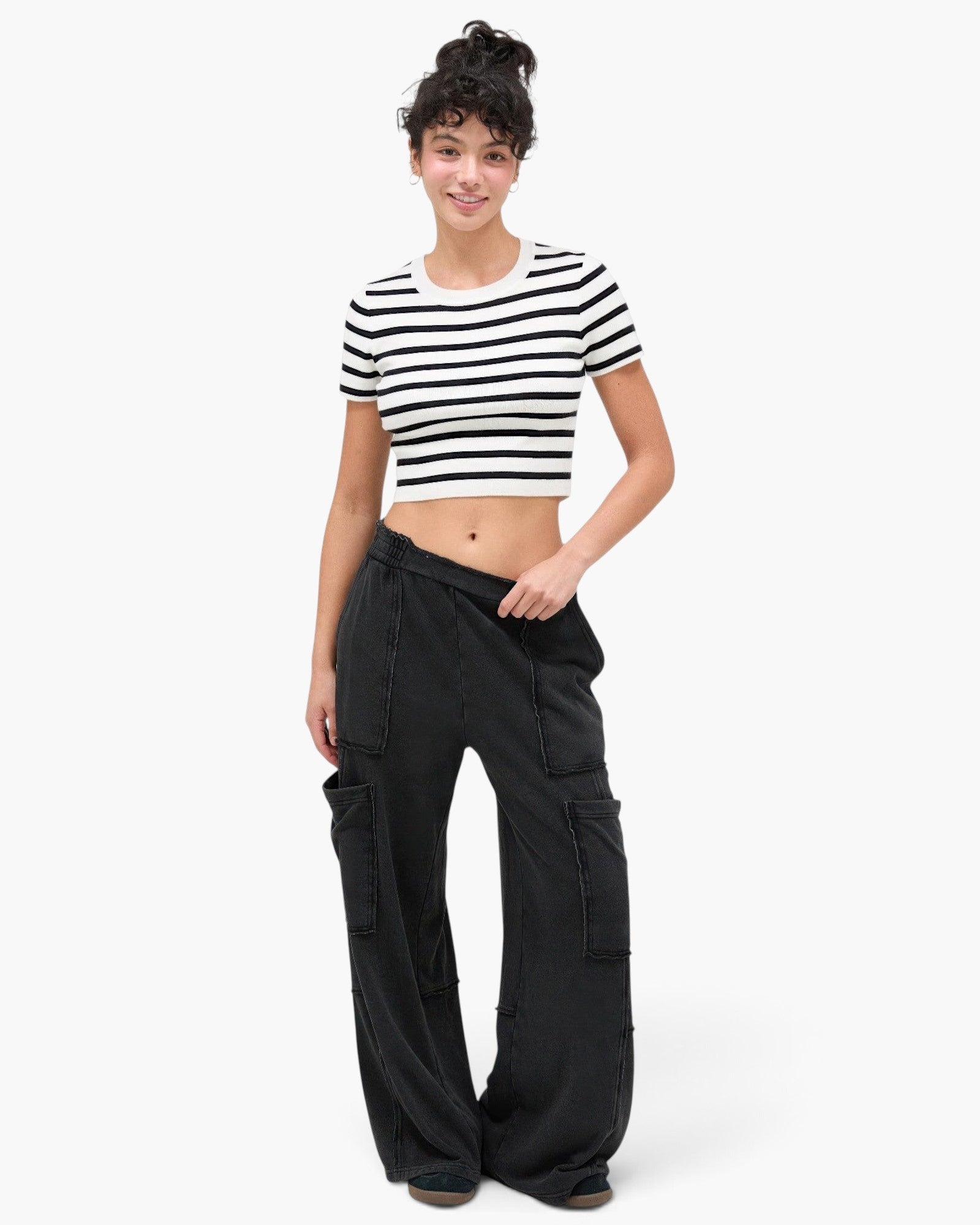 Model wearing Beach Rose Co. black mineral wash cotton wide leg cargo pants with raw edge pockets and elastic waist