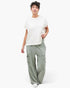Beach Rose Co. mineral wash wide leg cargo pants in sage green with raw edge pockets paired with a white t-shirt