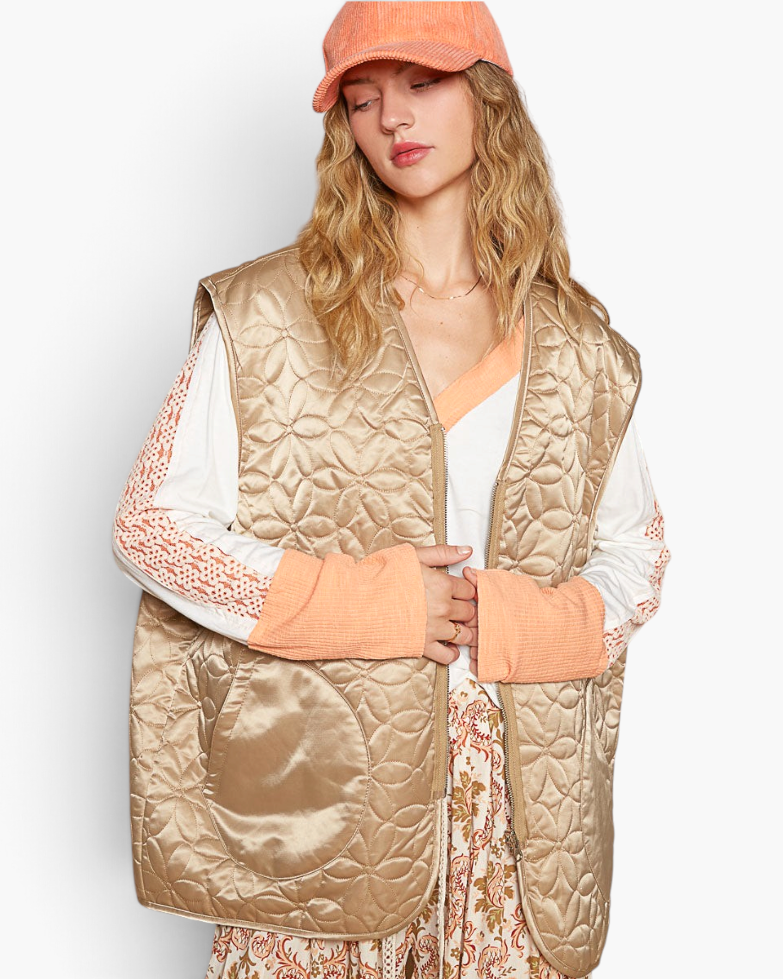 Beach Rose Co. mocha floral quilted zip-up vest with oversized patch pockets worn over a long-sleeve top and cap.