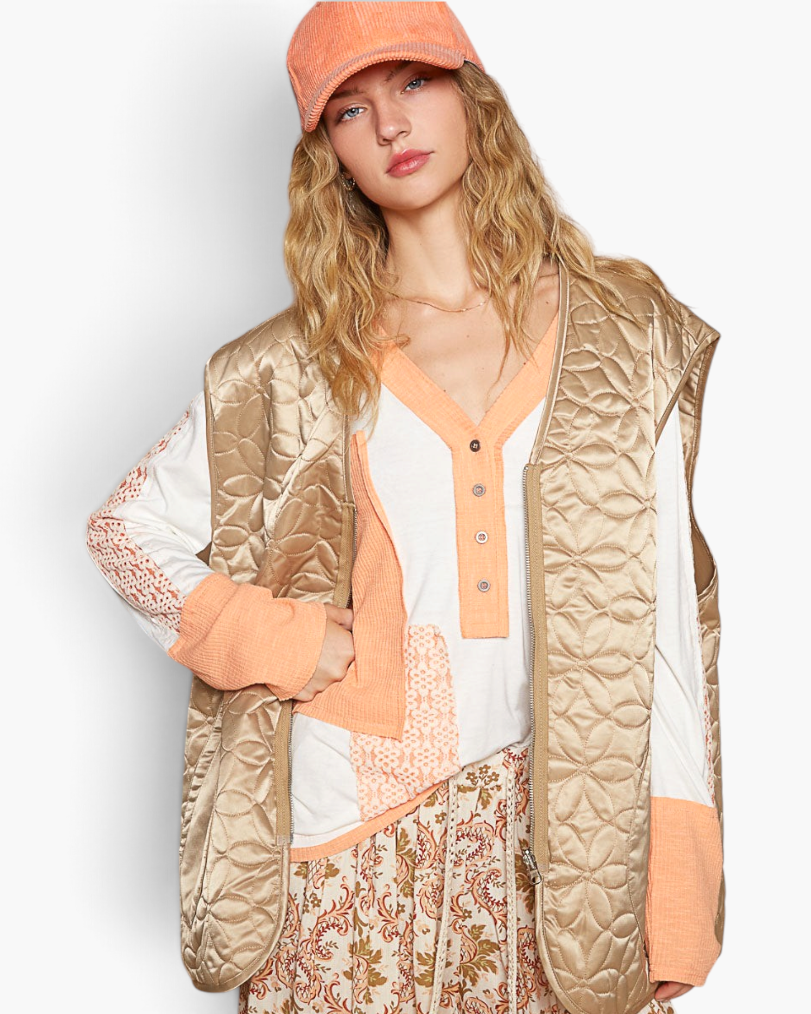 Beach Rose Co. mocha floral quilted zip-up vest with a subtle sheen worn over a long-sleeve top and matching cap.