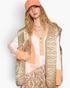 Beach Rose Co. mocha floral quilted zip-up vest with a subtle sheen worn over a long-sleeve top and matching cap.