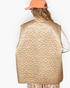 Beach Rose Co. mocha floral quilted nylon vest with a subtle sheen worn by a model in a peach corduroy baseball cap.