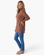 Beach Rose Co. model wearing a mocha brown ribbed turtleneck tunic sweater with side slits and blue jeans
