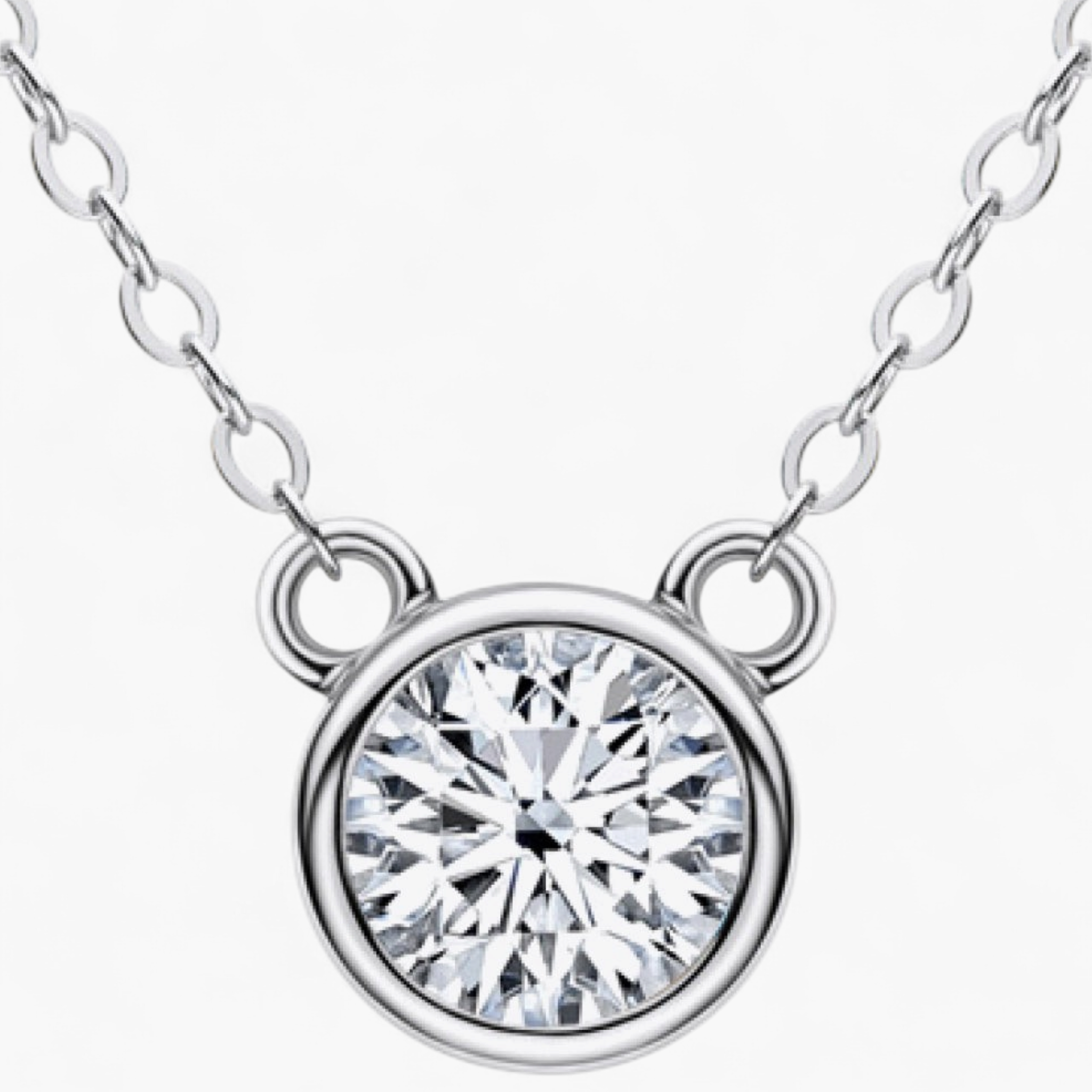 Beach Rose Co. 1 carat round moissanite solitaire necklace in a silver bezel setting on a delicate link chain.