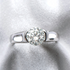 Beach Rose Co. 2 carat round moissanite solitaire ring in platinum-plated sterling silver with a half-bezel setting.