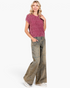 Beach Rose Co. model wearing mud-wash wide-leg jeans with patch pockets and a pink cable-knit sweater