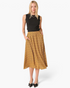 Beach Rose Co. mustard midi skirt with geometric print, elastic waistband, and side pockets on a blonde model.