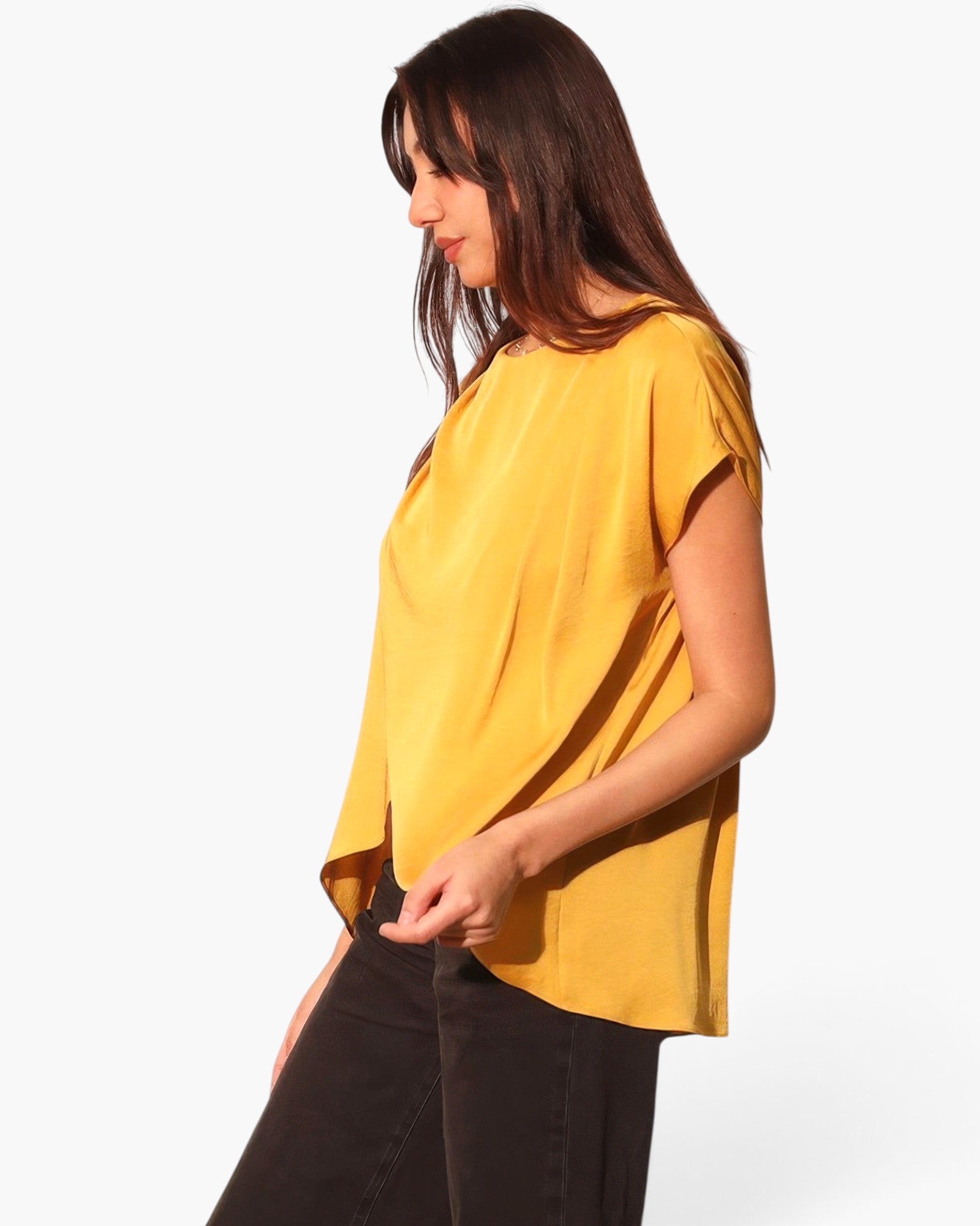 Beach Rose Co. mustard yellow washed poly silk tunic top with a tulip hemline worn by a model in a side view