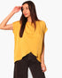 Beach Rose Co. mustard yellow washed poly silk tulip tunic top worn by a model with black trousers
