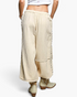 Beach Rose Co. natural cotton double-gauze jogger pants with studded side seams and raw-edge details, back view.