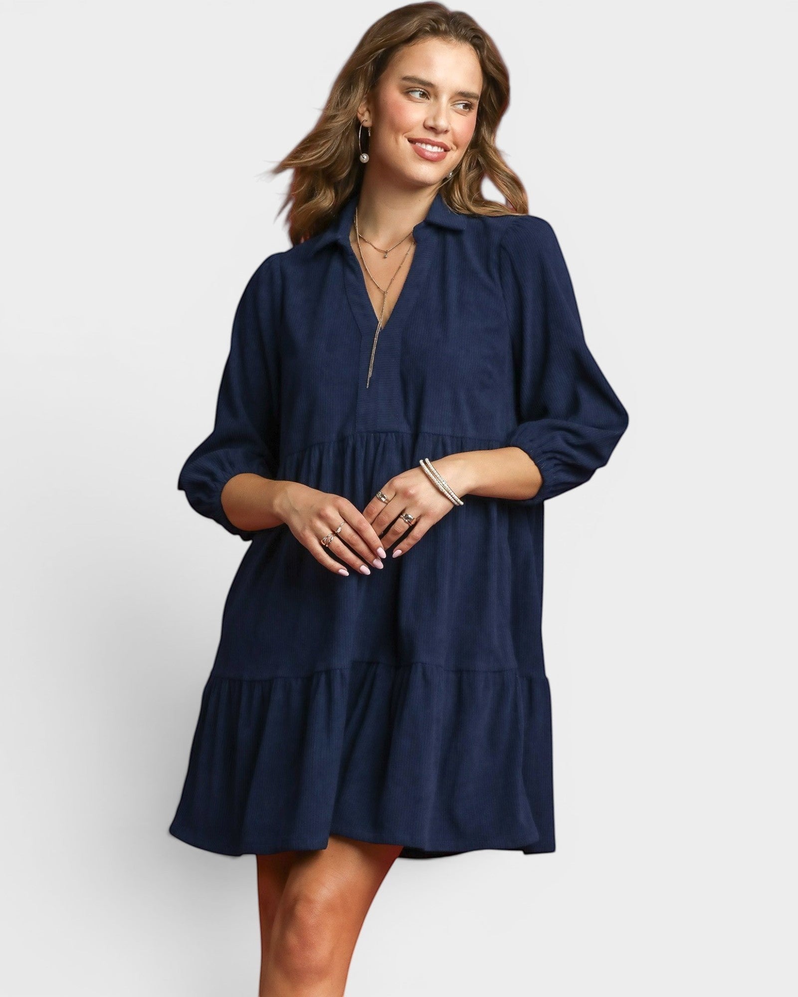 Beach Rose Co. navy corduroy tiered mini dress with collared split neckline, puff sleeves, and side pockets.