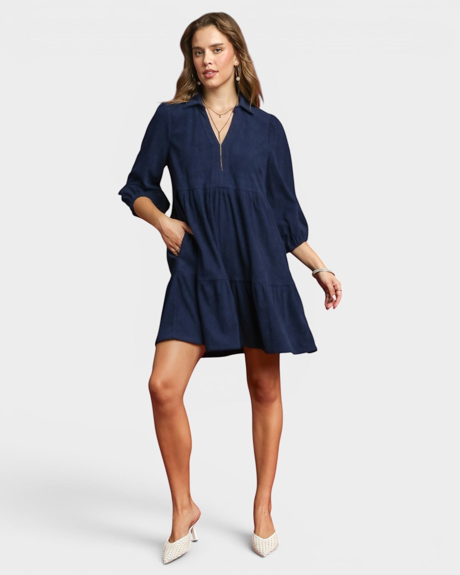 Beach Rose Co. navy corduroy tiered mini dress with collared split neckline, puff sleeves, and side pockets.