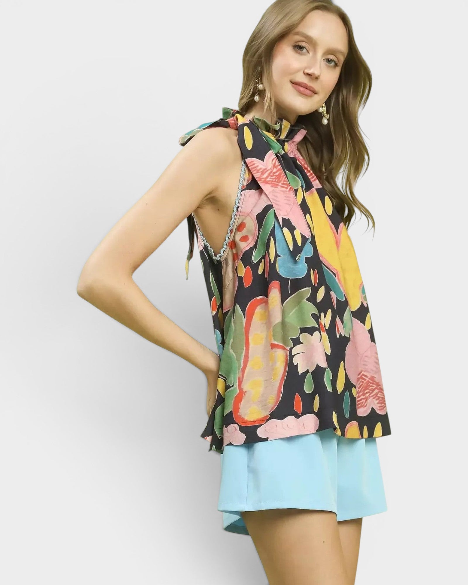 Beach Rose Co. navy halter top with a colorful abstract floral print, tie-back neck, and flowy silhouette.