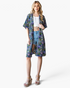 Beach Rose Co. navy longline kimono with a colorful floral print, open front, and relaxed fit worn by a model.