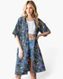 Model wearing a Beach Rose Co. navy longline kimono with a colorful floral print, open front, and relaxed fit.