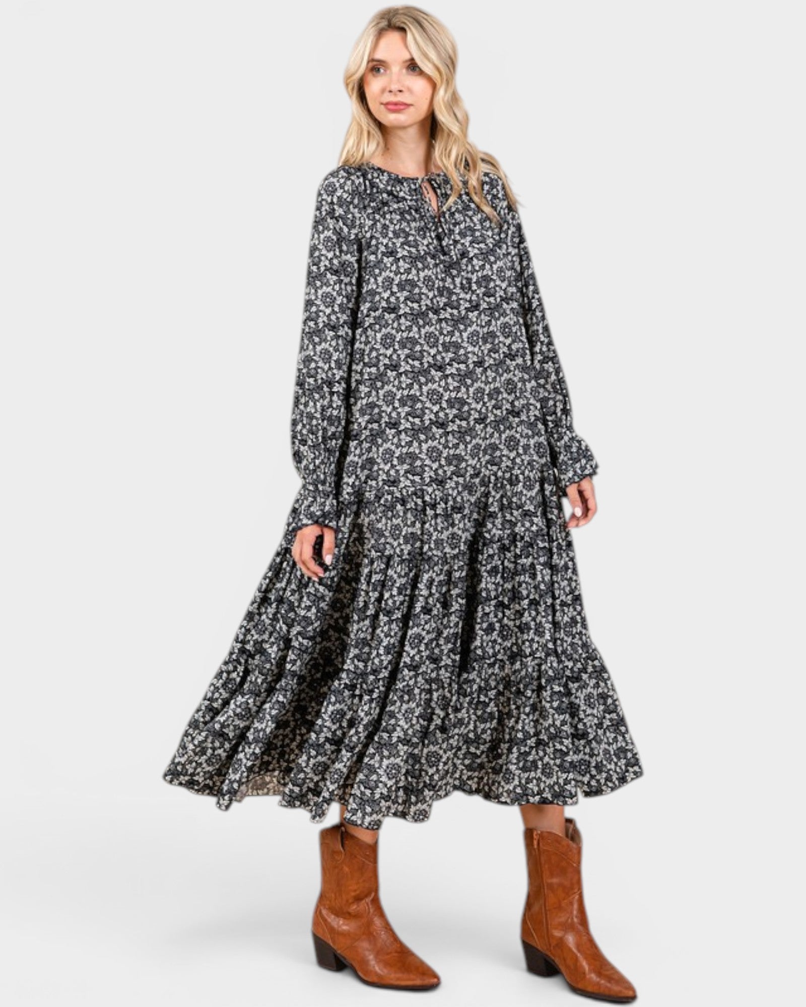 Beach Rose Co. navy floral maxi dress with long sleeves, tie neckline, and tiered skirt, styled with brown boots.