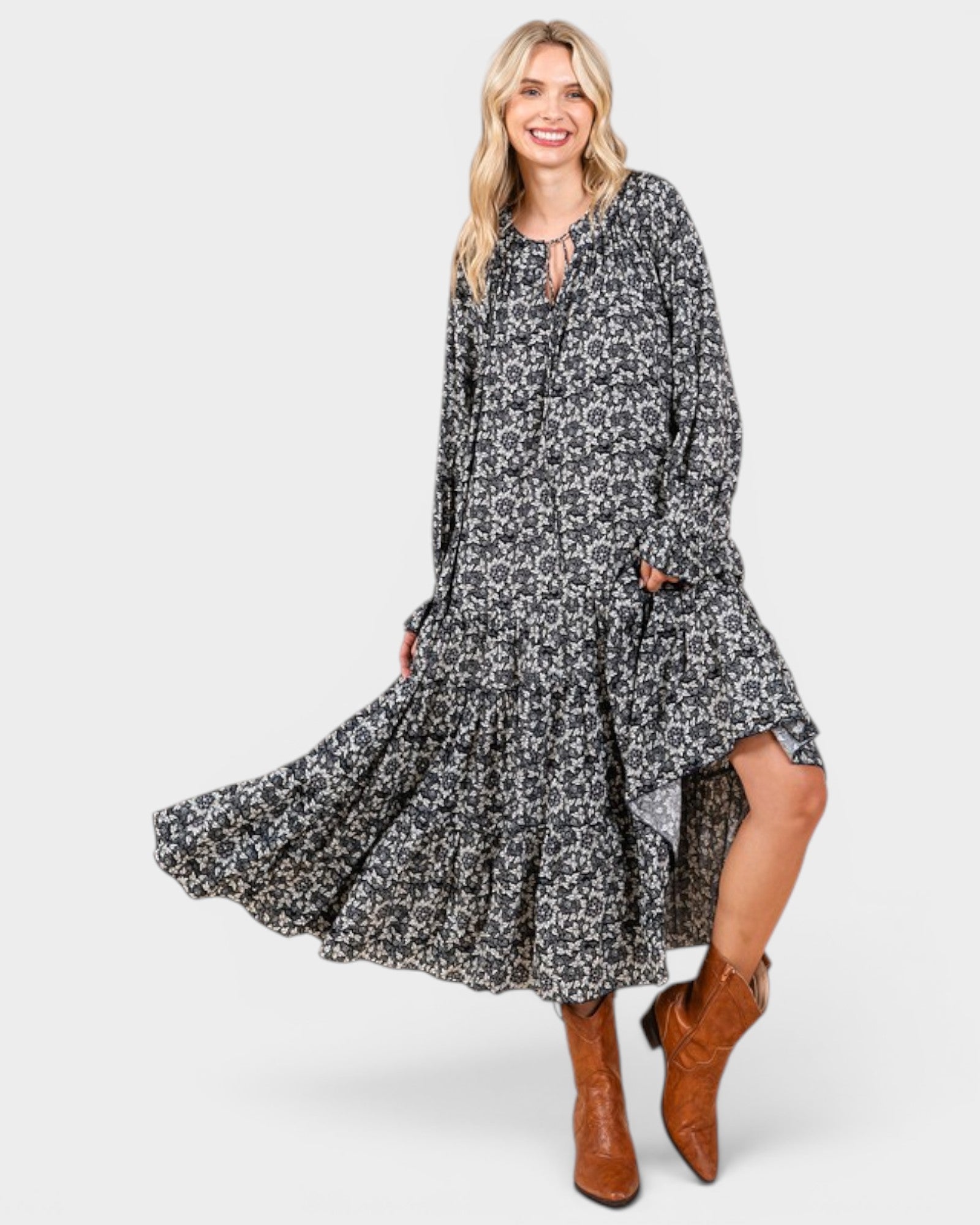 Beach Rose Co. navy floral tiered maxi dress with long sleeves and tie neckline worn with brown leather boots