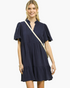 Beach Rose Co. navy linen blend mini dress with scalloped puff sleeves, tiered skirt, and split neckline on a model.