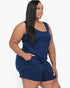 A model wearing a navy Beach Rose Co. plus size tank top and shorts set made from soft, stretchy jersey fabric.