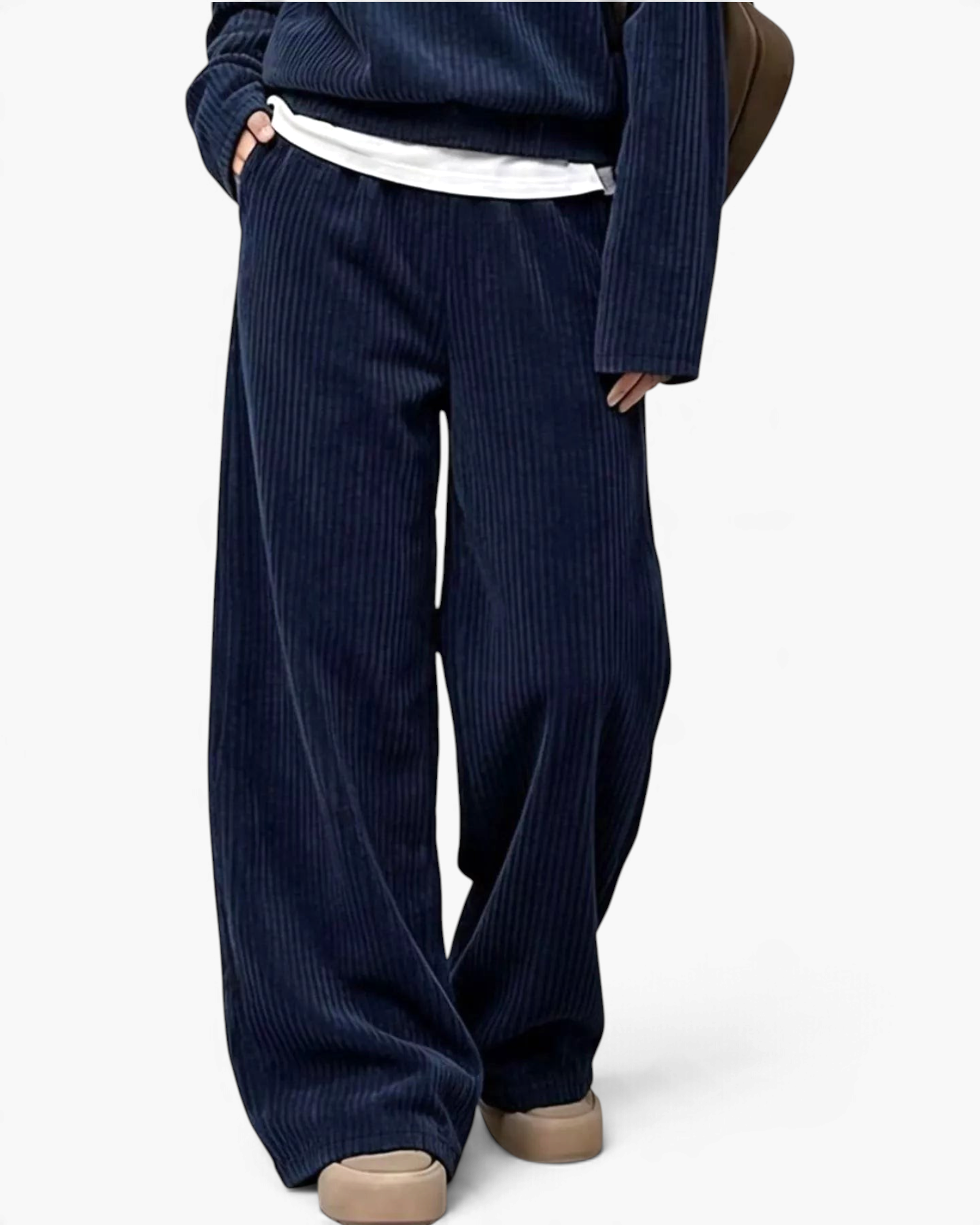 Beach Rose Co. navy blue ribbed two-piece set with a collared top and wide leg pants worn with beige shoes.