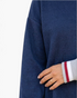 Beach Rose Co. navy textured sweatshirt with dropped shoulders and striped ribbed cuff detail on a model