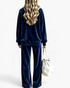 Beach Rose Co. navy blue velour lounge set with a relaxed crewneck top and wide leg pants, worn by a blonde model.
