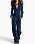Beach Rose Co. navy blue velour jumpsuit with a stand collar, zip-front closure, and wide-leg silhouette.