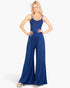 Beach Rose Co. navy blue wide-leg jumpsuit with button-front detail and spaghetti straps worn by a blonde model