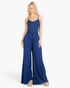 Beach Rose Co. navy blue button-front wide-leg jumpsuit worn by a blonde model against a white background