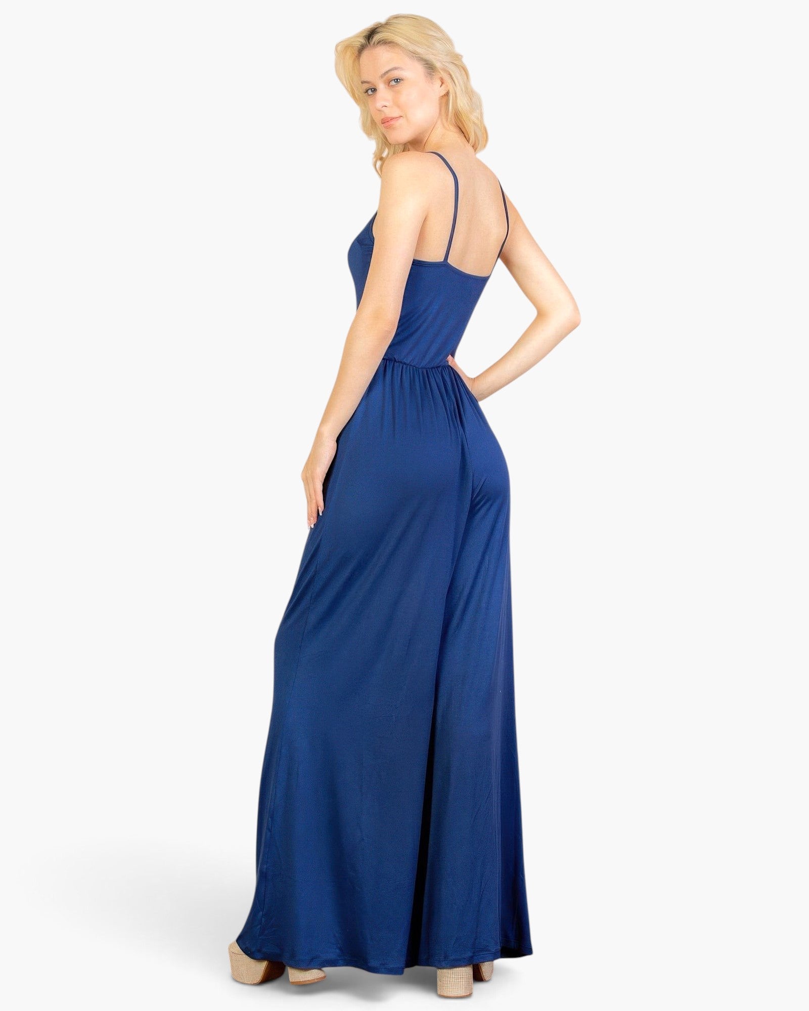 Beach Rose Co. navy blue wide-leg jumpsuit with spaghetti straps worn by a blonde model on a white background