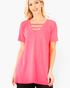 Beach Rose Co. neon pink tunic top with a V-neckline and strappy detail worn by a blonde model