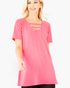 Beach Rose Co. neon pink V-neck tunic top with strappy neckline detail worn by a blonde model on a white background