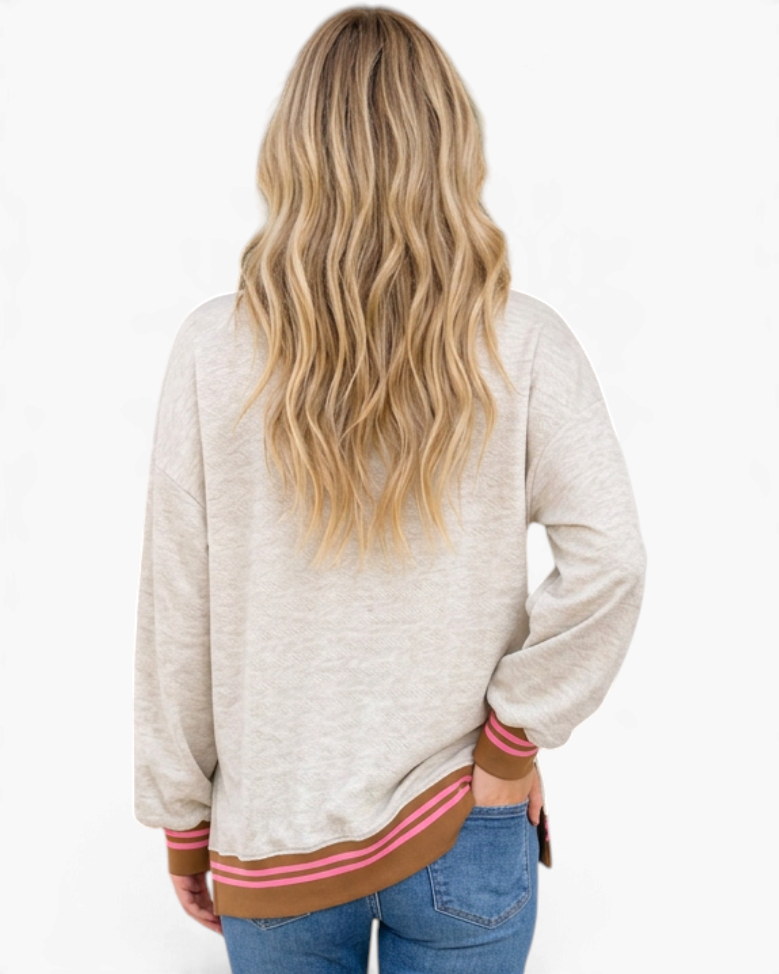 Back view of a woman wearing a Beach Rose Co. oatmeal sweatshirt with brown and pink striped trim and dropped shoulders