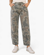Beach Rose Co. olive camouflage cropped utility pants with stitched knee panels and front pockets on a model.