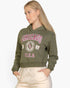 Beach Rose Co. olive green drop shoulder hoodie with Chicago graphic print worn by a blonde model