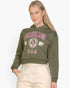 Beach Rose Co. olive green drop shoulder pullover hoodie with Chicago graphic print worn by a blonde model.