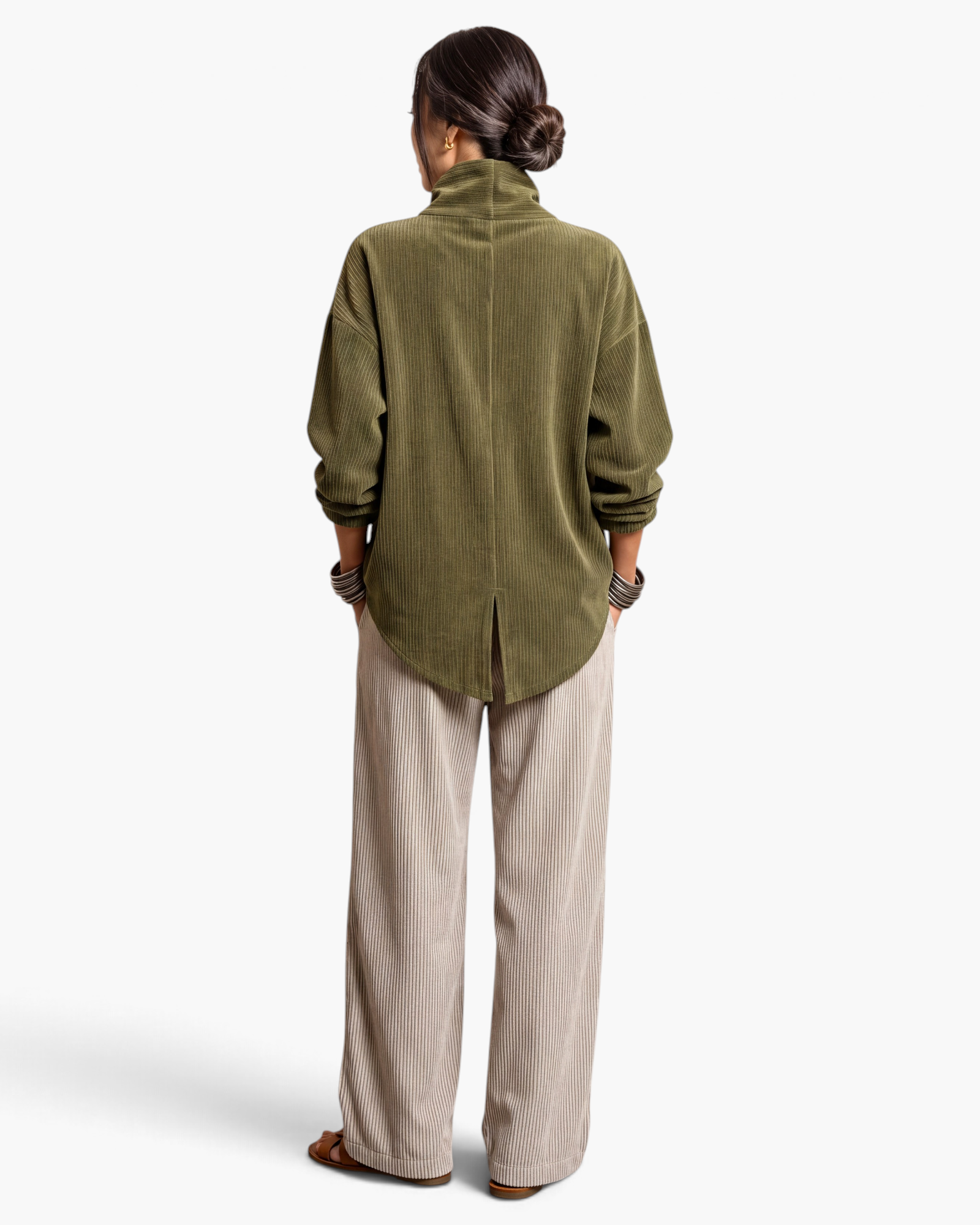 Beach Rose Co. olive corduroy jacket with a back vent and relaxed fit worn with beige trousers, rear view.