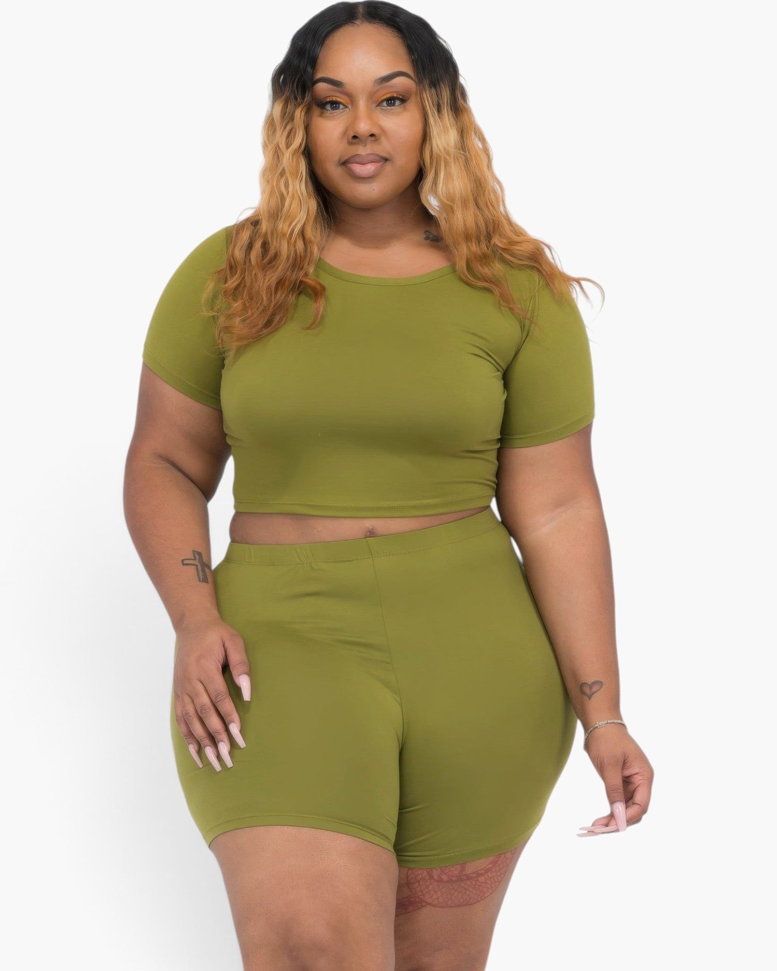 Beach Rose Co. plus size olive green short sleeve crop top and matching shorts set on a woman with long wavy hair.