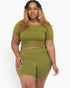 Beach Rose Co. plus size olive green short sleeve crop top and matching shorts set on a woman with long wavy hair.