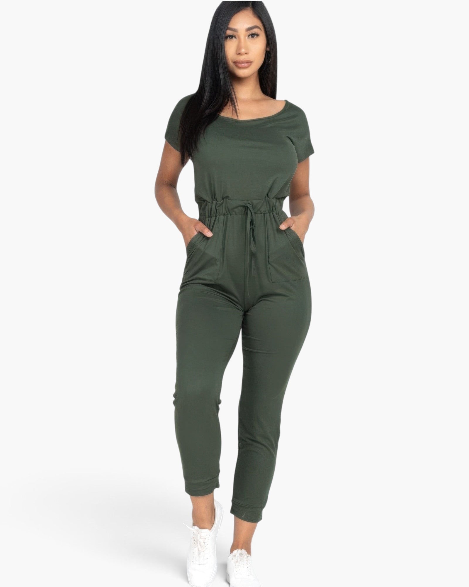 Beach Rose Co. olive green two-way shoulder drawstring jumpsuit worn by a woman with white sneakers