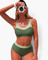 Beach Rose Co. two-piece colorblock bikini in olive green with a sleeveless top and back knot detail on a model