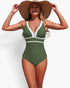 Beach Rose Co. olive green one-piece swimsuit with white V-neck trim and color block design worn by a woman in a hat.