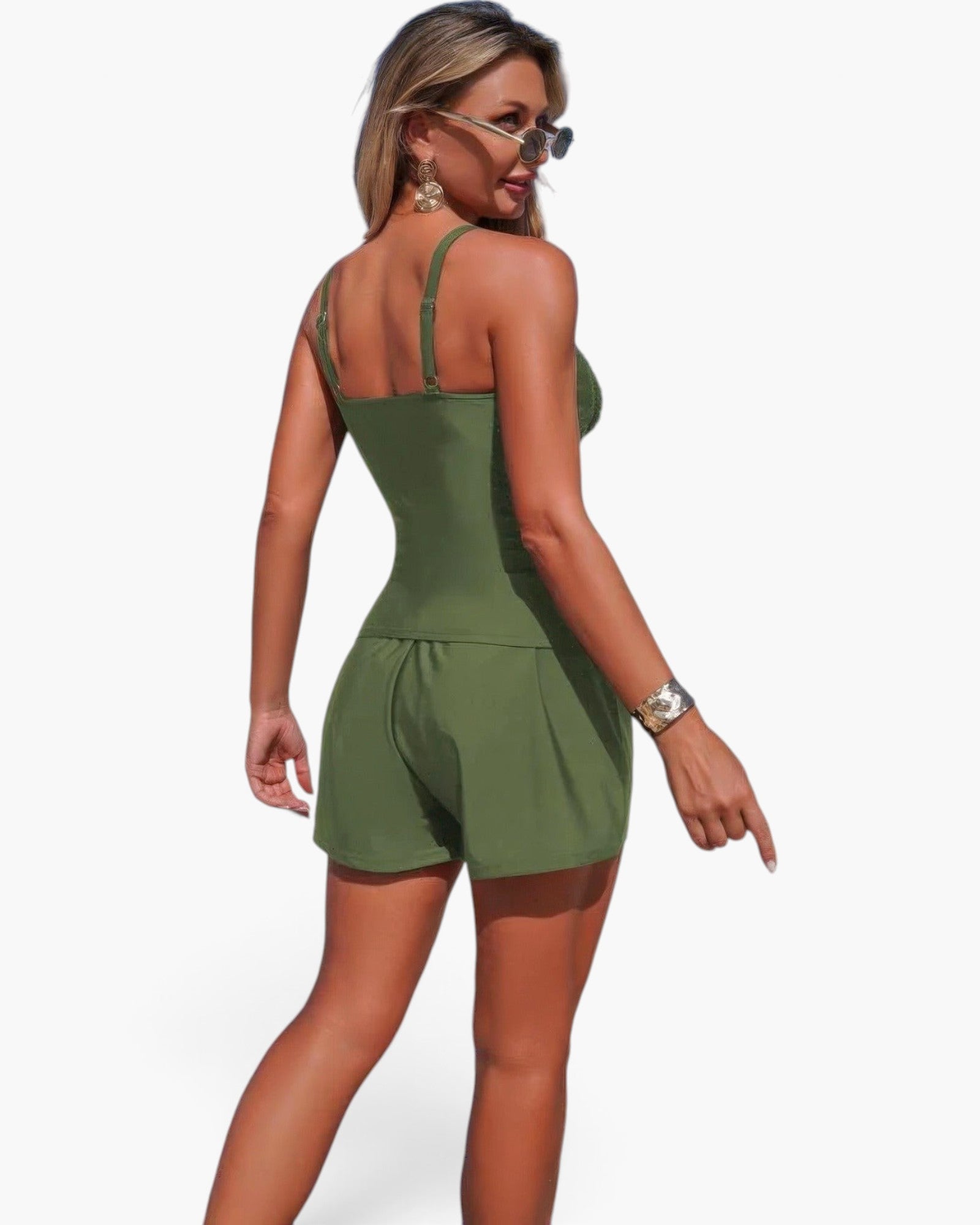 Beach Rose Co. olive green two-piece swimsuit with sling straps, pleated shorts, and pocket details on a model.