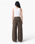Beach Rose Co. brown leopard print barrel-leg jeans with buttoned back flap pockets and a relaxed fit.