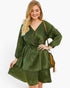 Beach Rose Co. plus size olive green V-neck dress with long sleeves and a ruffled hem on a smiling blonde model